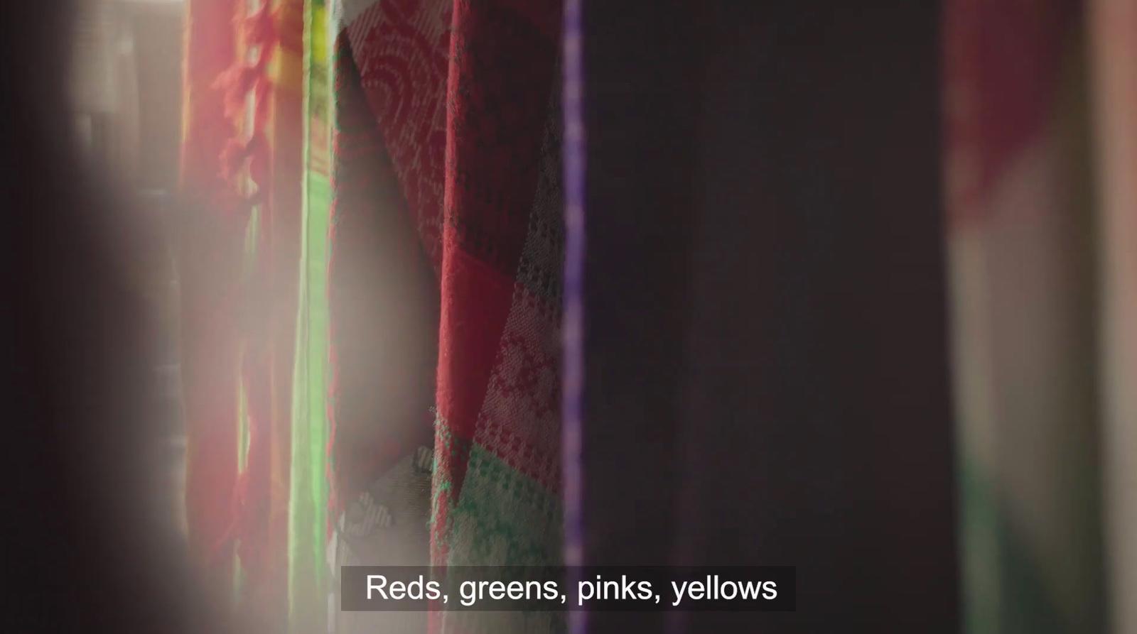 a blurry photo of a curtain with a red, green, pink, yellow