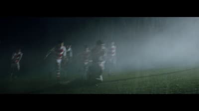 a group of soccer players playing in the rain