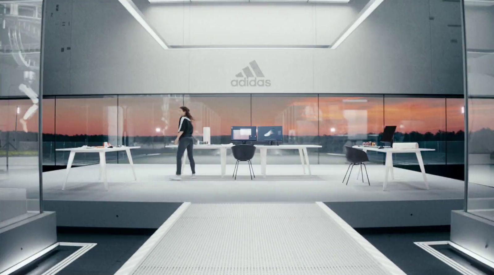 a person standing in a room with a desk and chairs