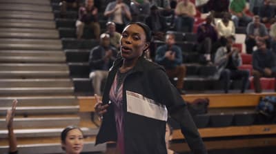 a woman standing in front of a crowd of people