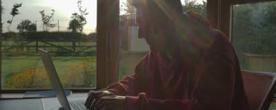 a person sitting in front of a laptop computer