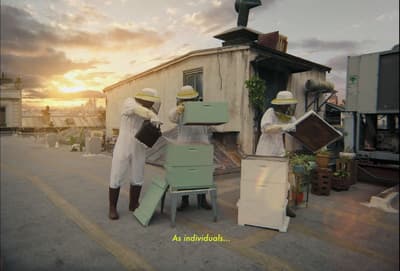 a group of beekeepers standing in front of a building