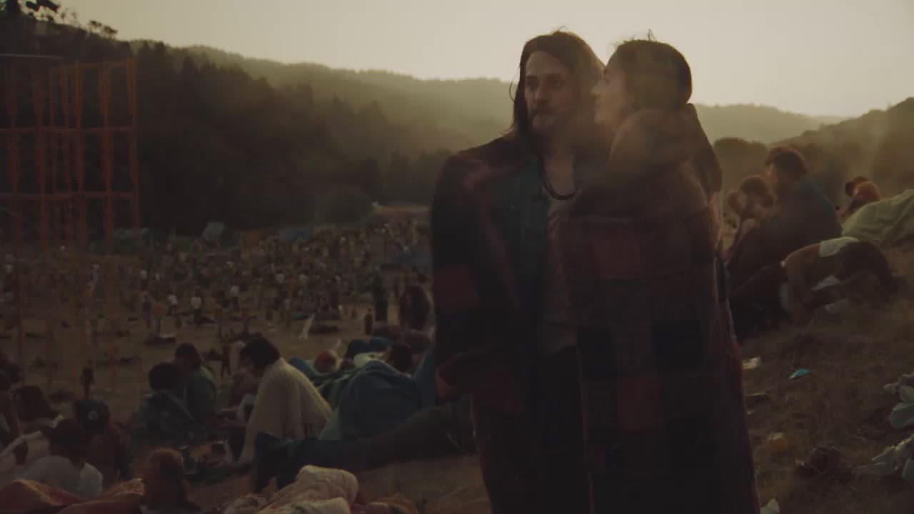 a man and woman standing in front of a crowd of people