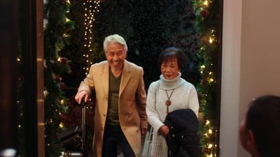 a man and a woman walking through a doorway