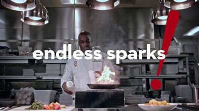 a man standing in a kitchen preparing food