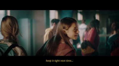a group of girls in a hallway talking to each other
