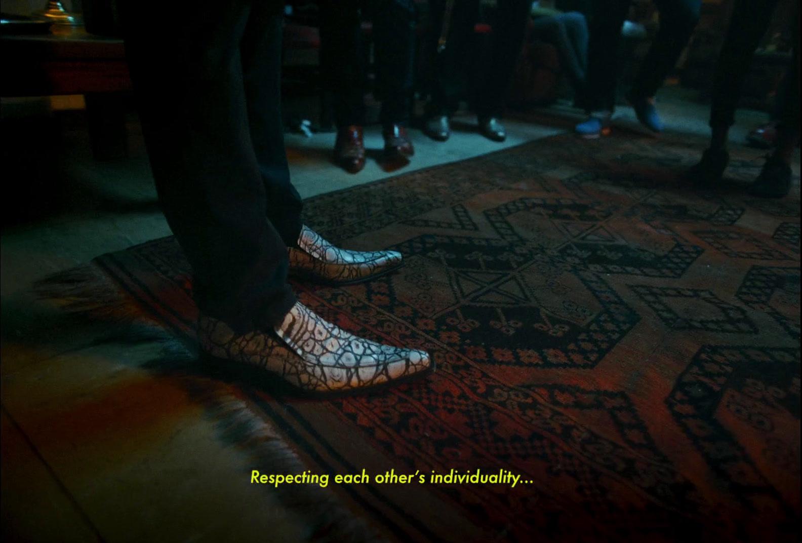 a group of people standing in front of a rug