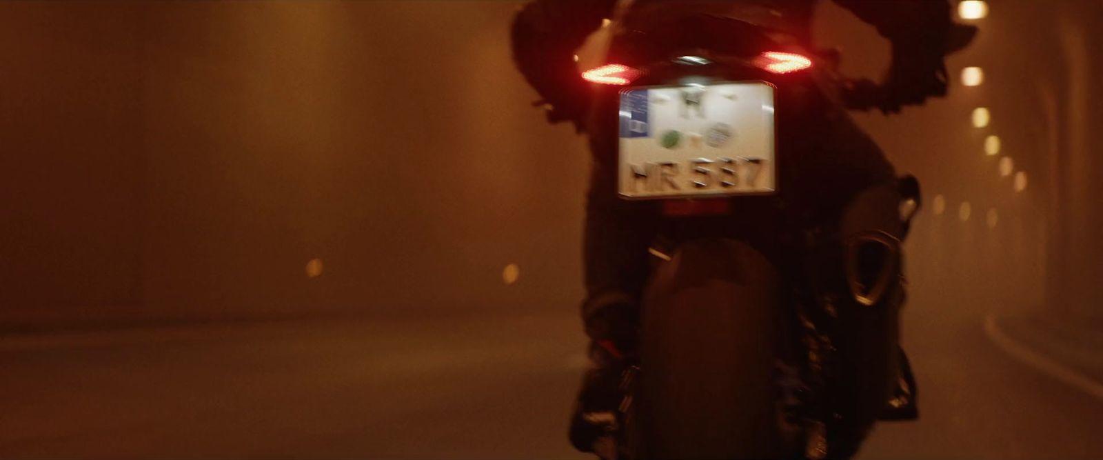 a person riding a motorcycle in a tunnel