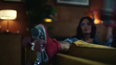 a woman sitting on a couch in a living room