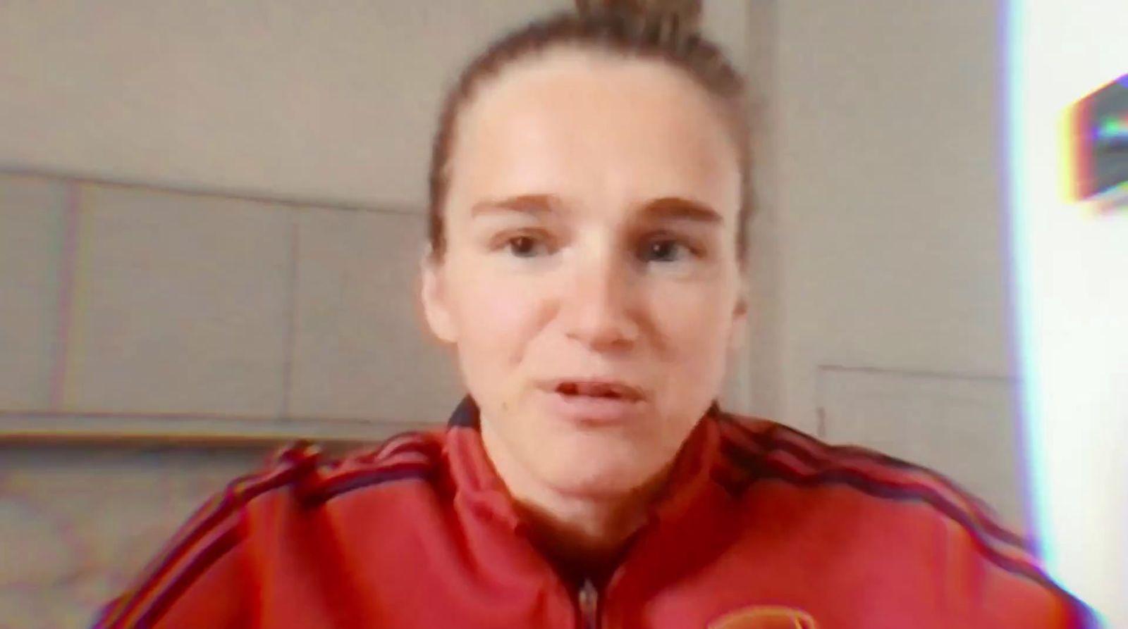 a woman in a red jacket is looking at the camera