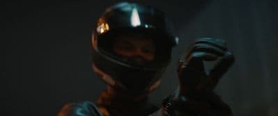 a man wearing a helmet and holding a glove
