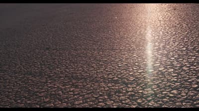 the sun is shining down on the asphalt