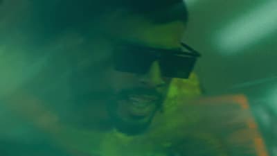 a man with sunglasses on talking on a cell phone