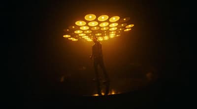 a person standing under a street light in the dark
