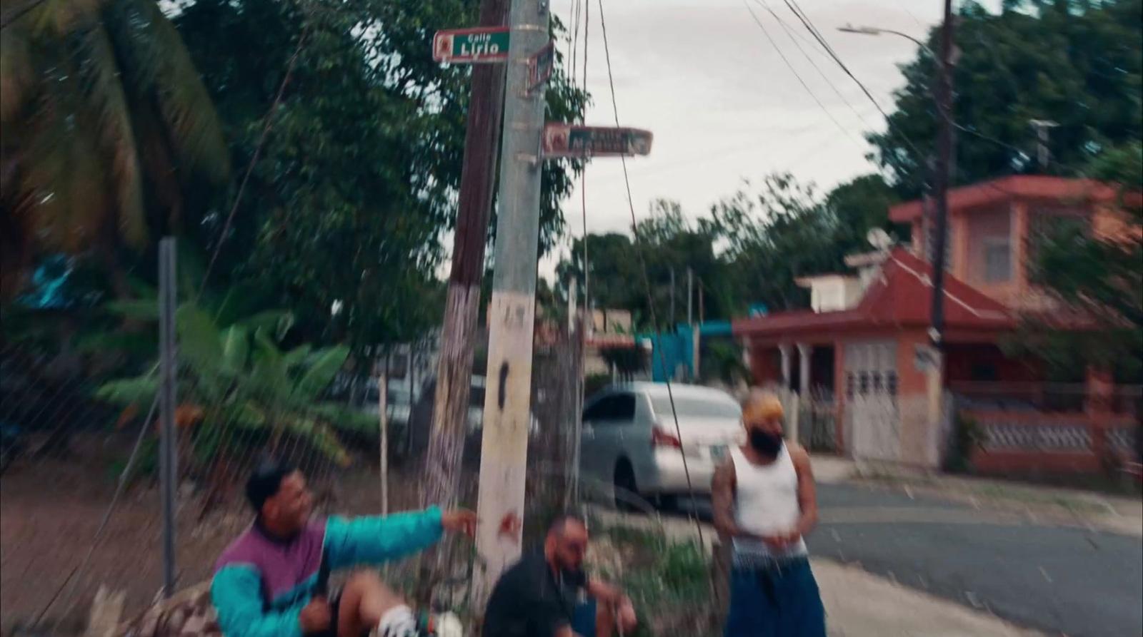 a group of people standing on the side of a road