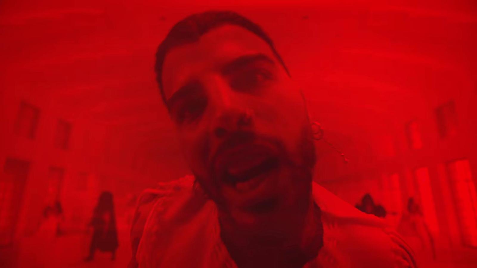 a man with his mouth open in a red room