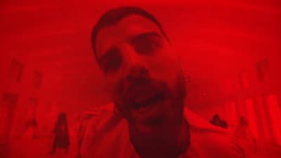 a man with his mouth open in a red room