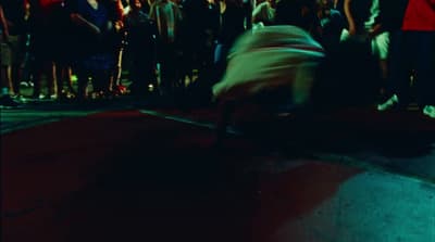 a crowd of people watching a person on a skateboard