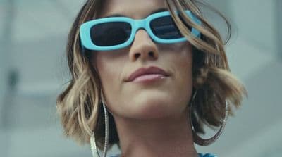 a woman wearing sunglasses and a necklace