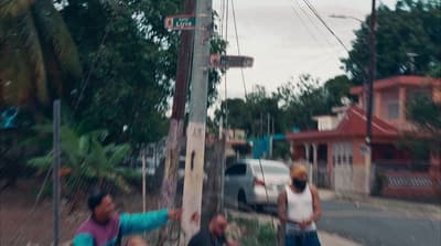 a group of people standing on the side of a road