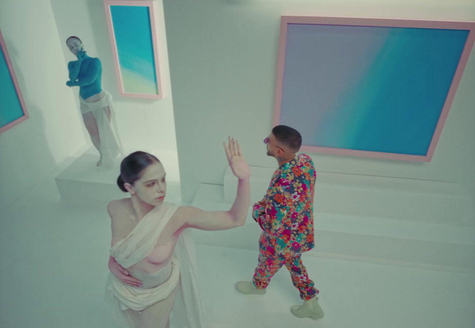 a woman standing next to a man in a room
