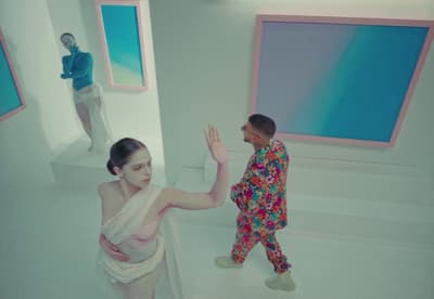 a woman standing next to a man in a room