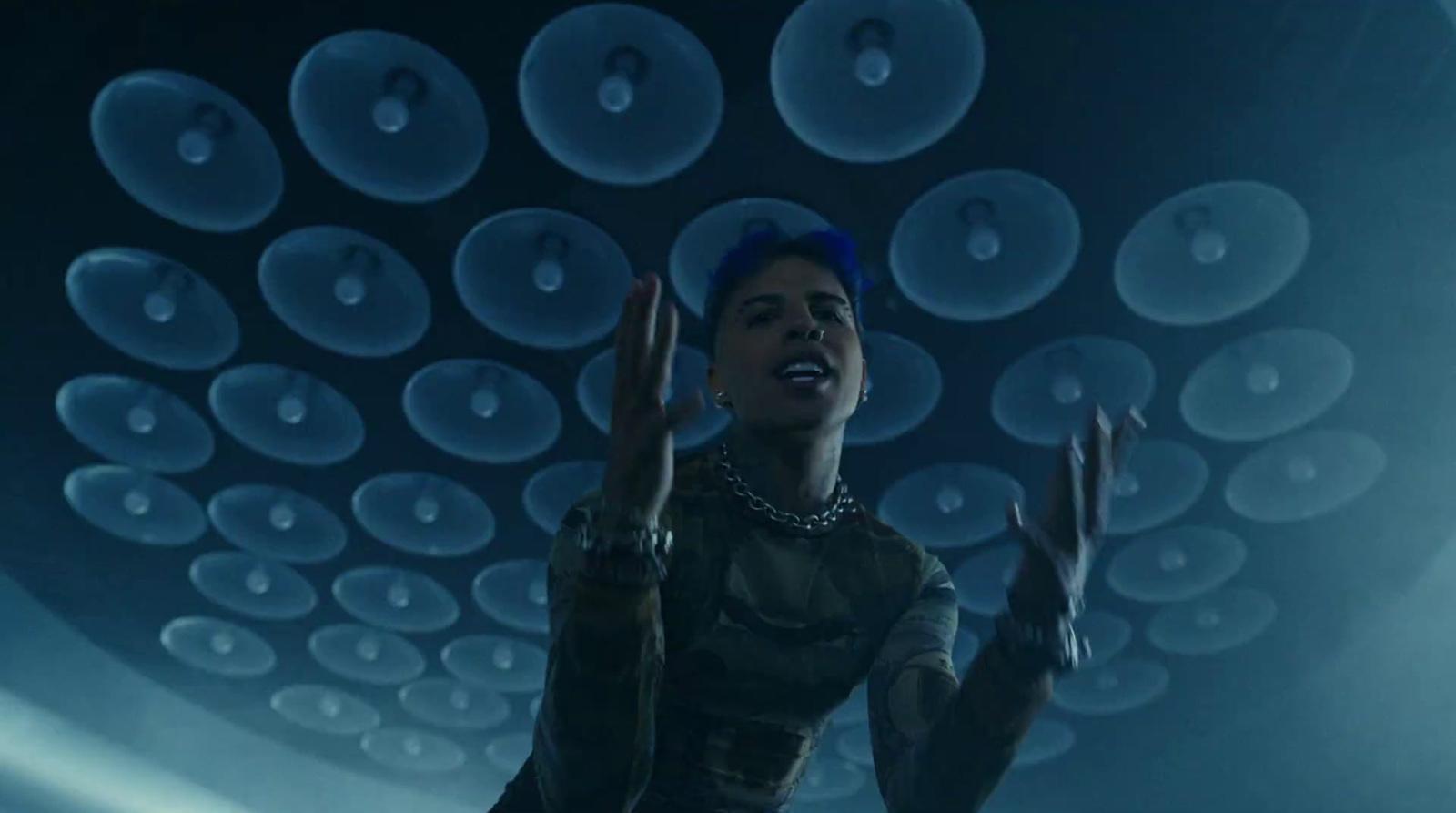 a woman standing in front of a ceiling of bubbles