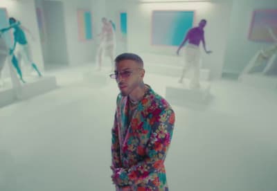 a man in a colorful suit standing in a room