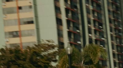 a stop sign in front of a tall building