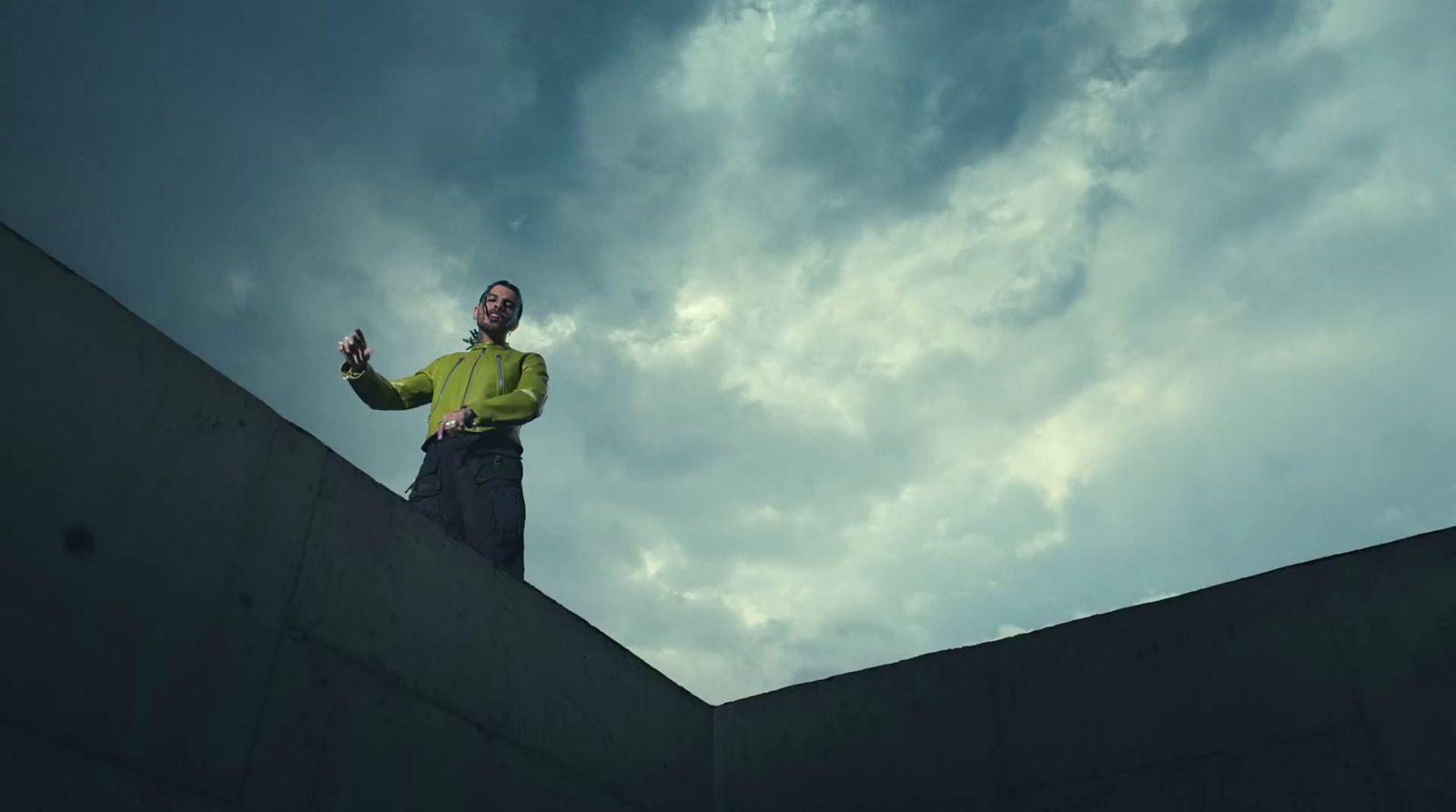 a man standing on top of a cement wall