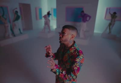 a man standing in front of a mirror in a room
