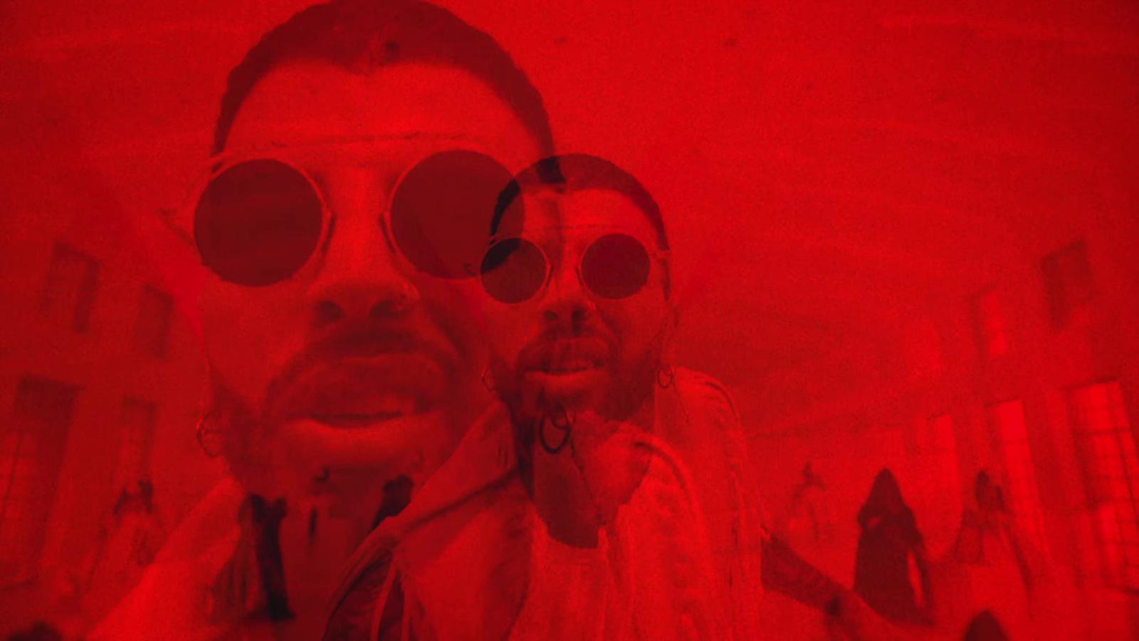 a man and a woman with red tinted glasses