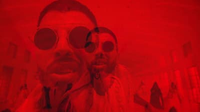 a man and a woman with red tinted glasses