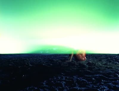 a person laying on the ground in the dark