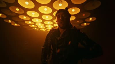 a man standing in front of a bunch of lights
