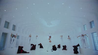a group of people standing in a white room