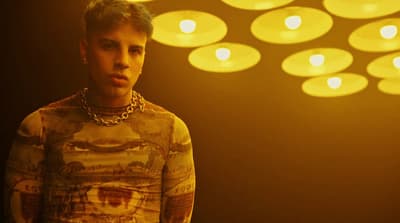 a man standing in front of a bunch of lights