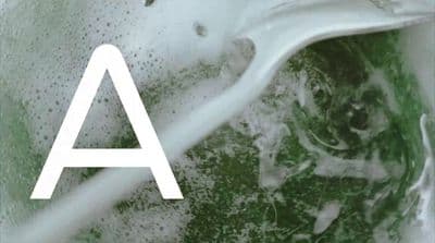 a green and white photo of a sink with the letter a on it