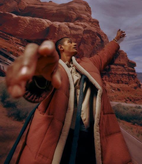 a man in a red jacket pointing at something