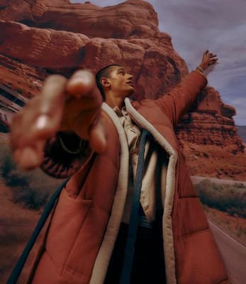 a man in a red jacket pointing at something