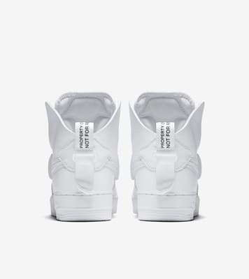 a pair of white sneakers on a white background