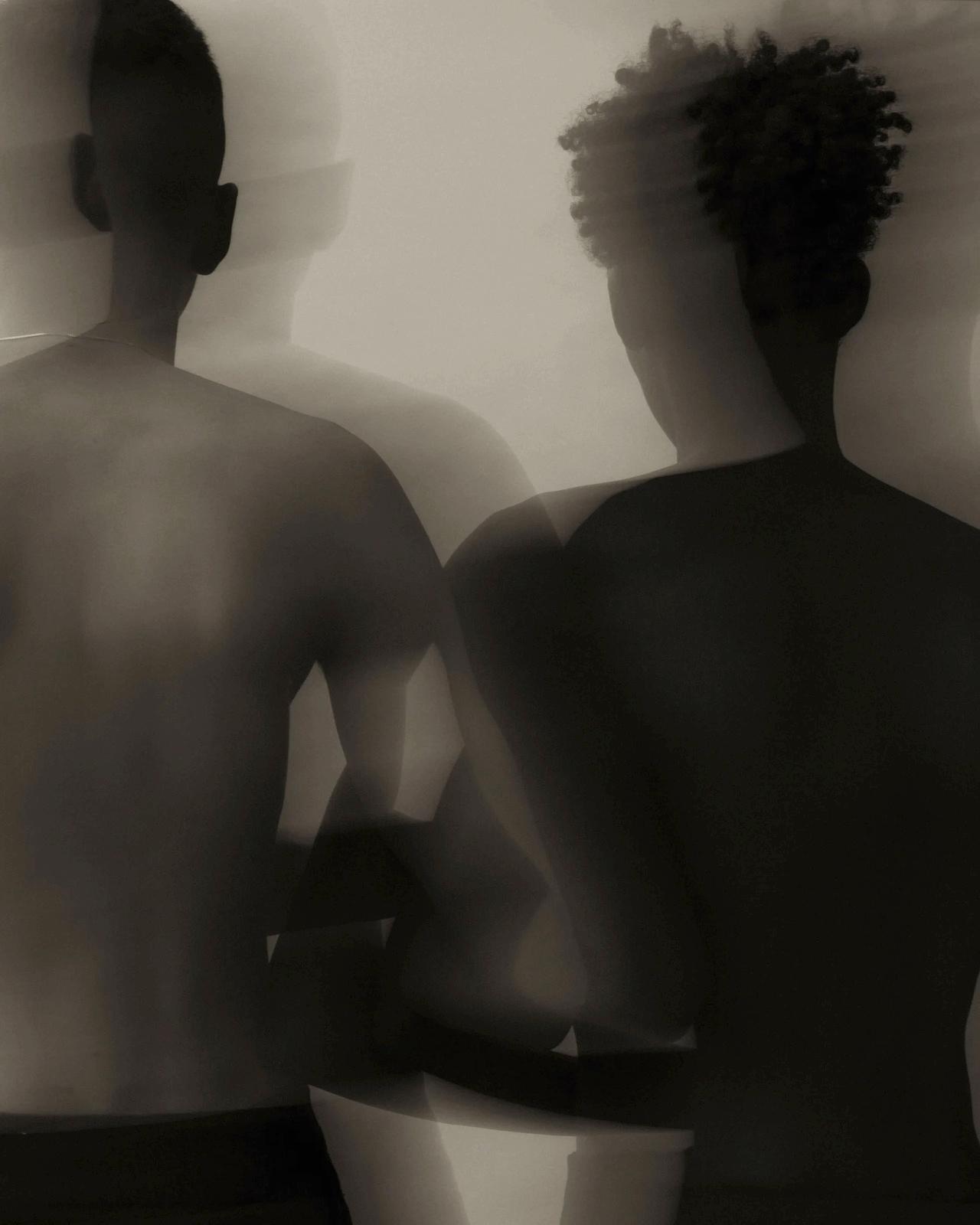 a man and a woman standing in front of a mirror