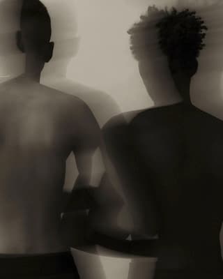 a man and a woman standing in front of a mirror