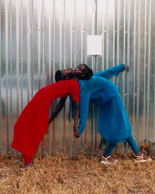 a couple of people that are leaning against a wall