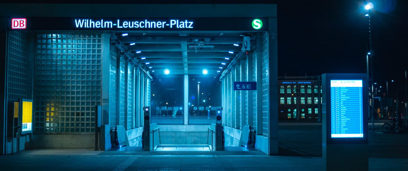 the entrance to a subway station at night