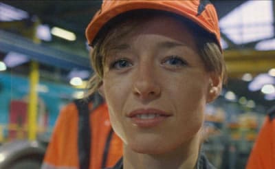 a woman wearing a hard hat in a factory