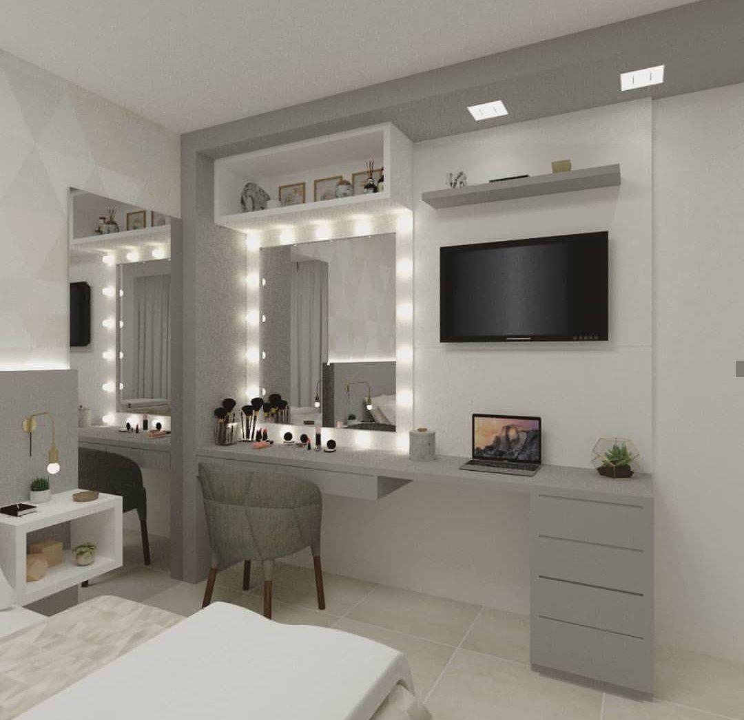 a bedroom with a bed, desk and television