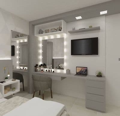 a bedroom with a bed, desk and television