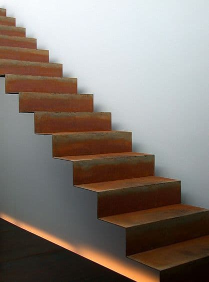 a set of stairs leading up to a white wall