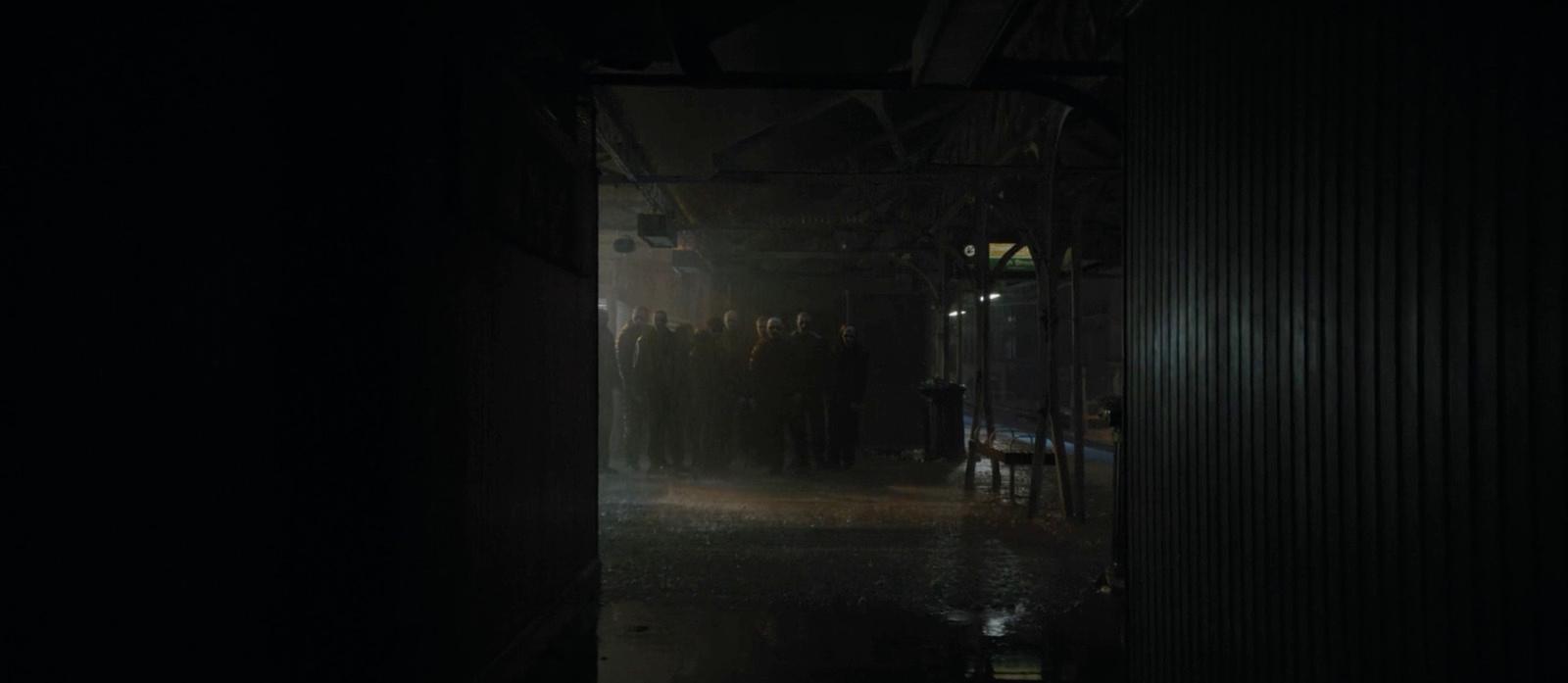 a group of people standing in a dark room